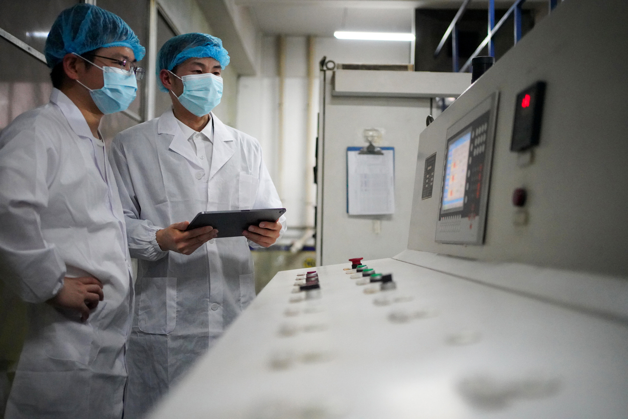 Two Technicians Analyzing Data on a Computer