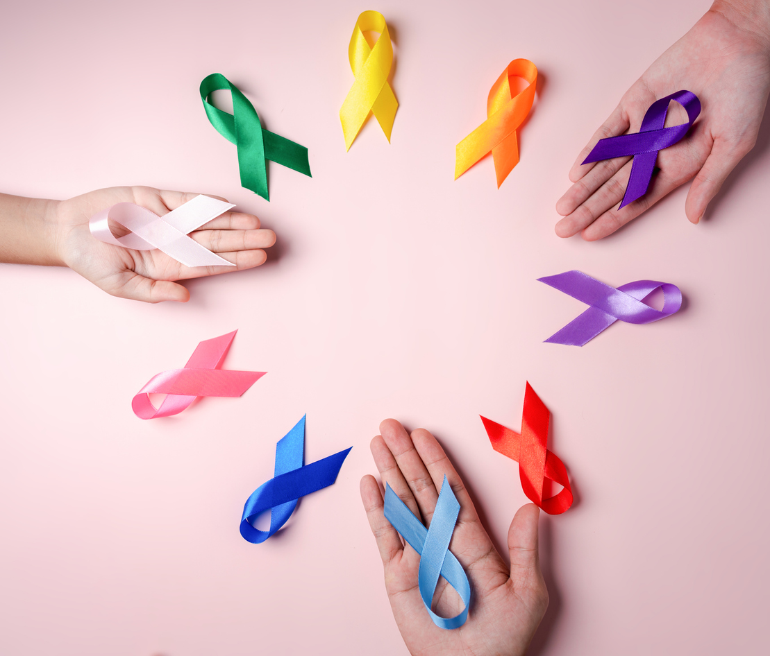 Hands Holding Colorful Cancer Awareness Ribbons